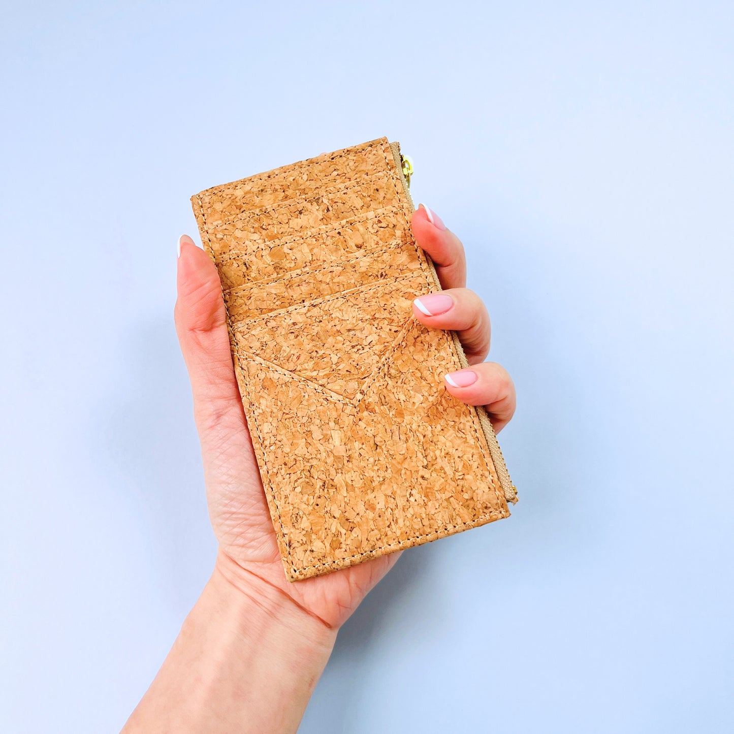 A woman's hand holding By The Sea Collection, Bernie, classic vegan cork leather card holder