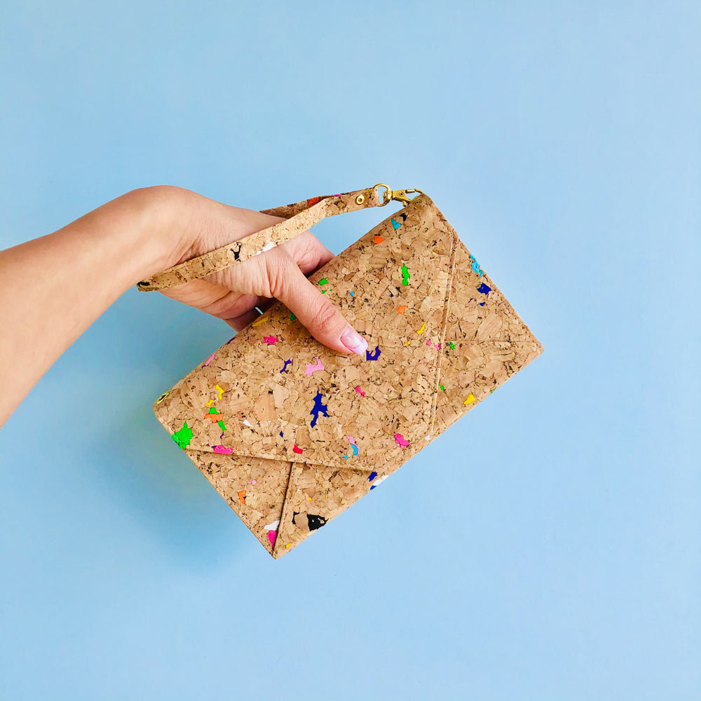 By The Sea Collection, model holding Flora with hand strap, colourful vegan cork leather shoulder bag, clutch bag
