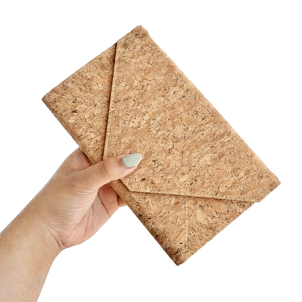 Model hand holding By The Sea Collection, Flora, classic vegan cork leather shoulder bag