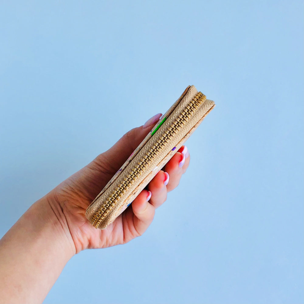 Model holding side view of By The Sea Collection, Ingy, colourful vegan cork leather wallet