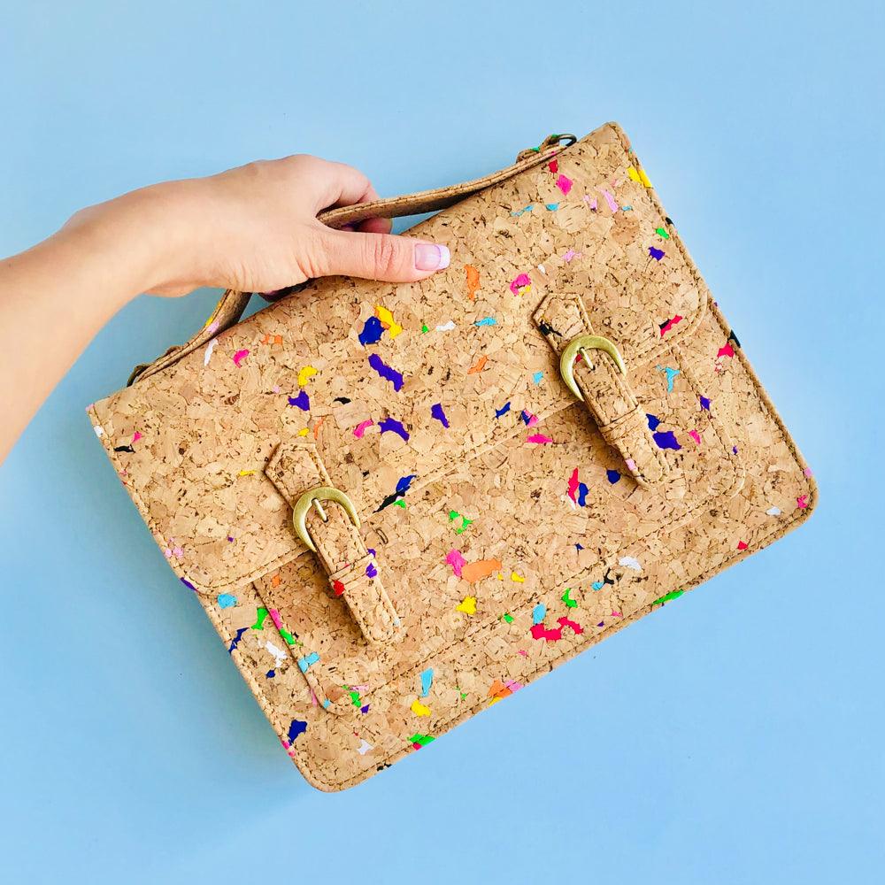 By The Sea Collection, model holding top handle of Keira, colourful vegan cork leather satchel shoulder bag