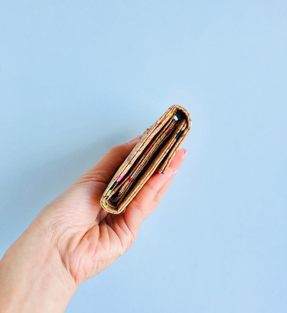 Model holding side way of By The Sea Collection, Laura, colourful vegan cork leather wallet