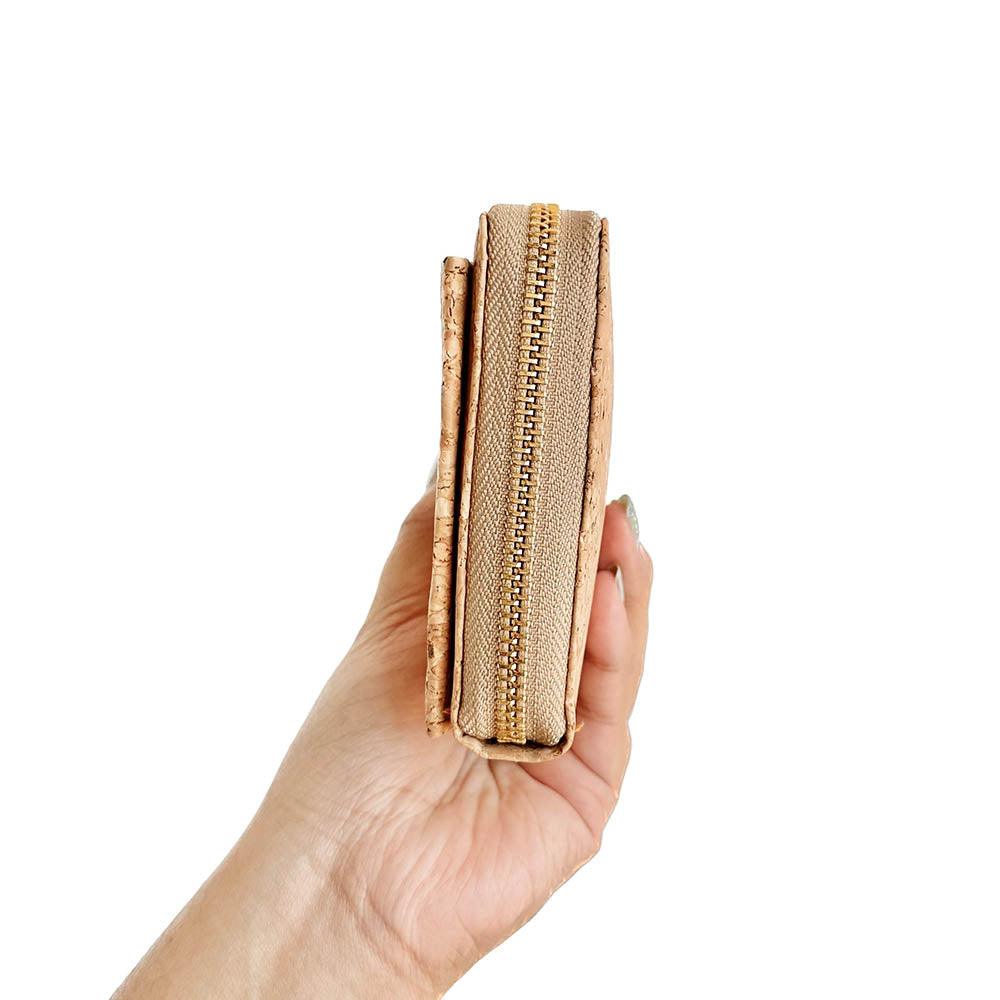 Model hand showing the side of By The Sea Collection, Nyla, classic cork cross body phone bag