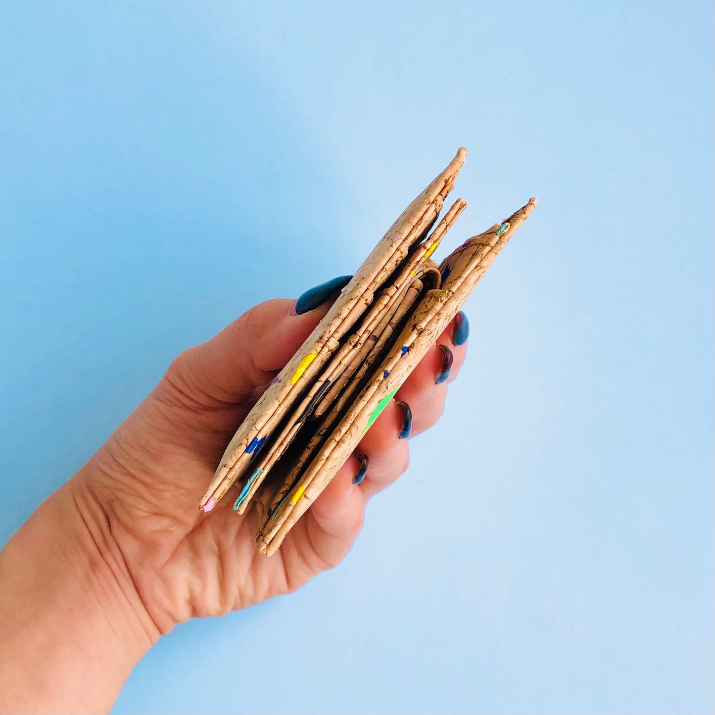 Model hand showing the side of By The Sea Collection, Gilly, colourful vegan cork leather compact wallet