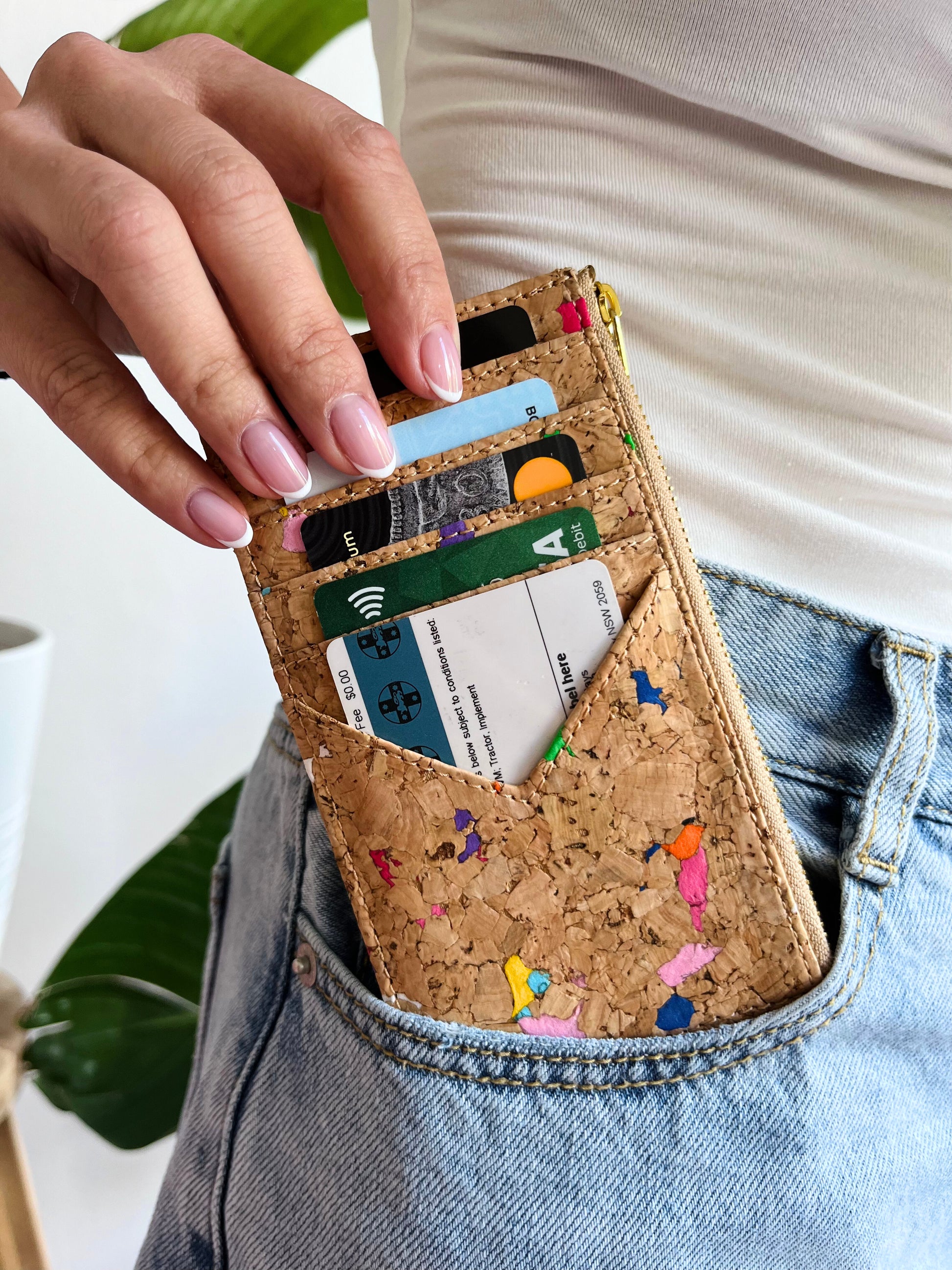 A woman holding By The Sea Collection, Bernie, colourful vegan cork leather card holder with cards inside card slots