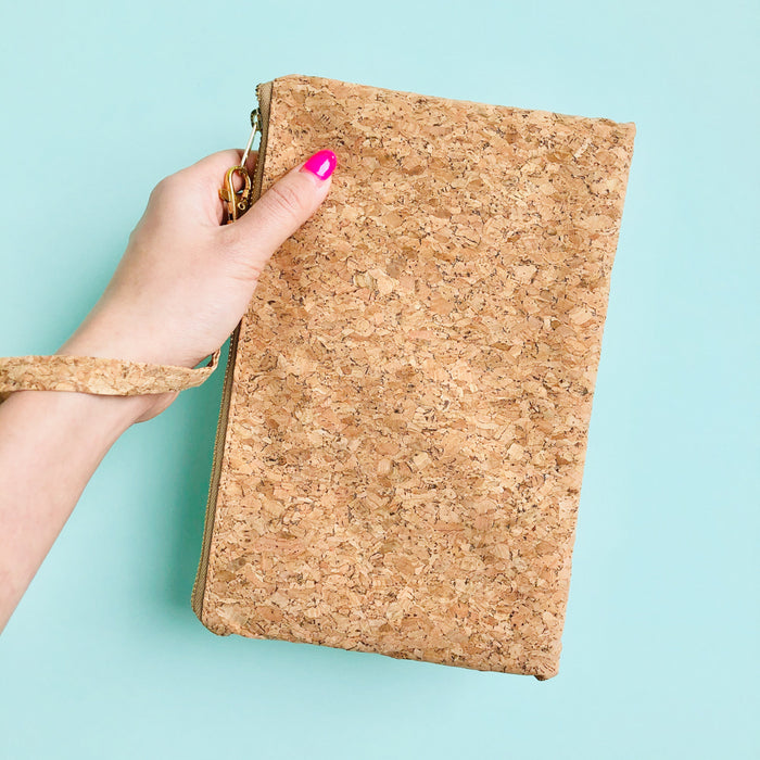 Woman using wristlet of By The Sea Collection, Annie, vegan cork leather pouch