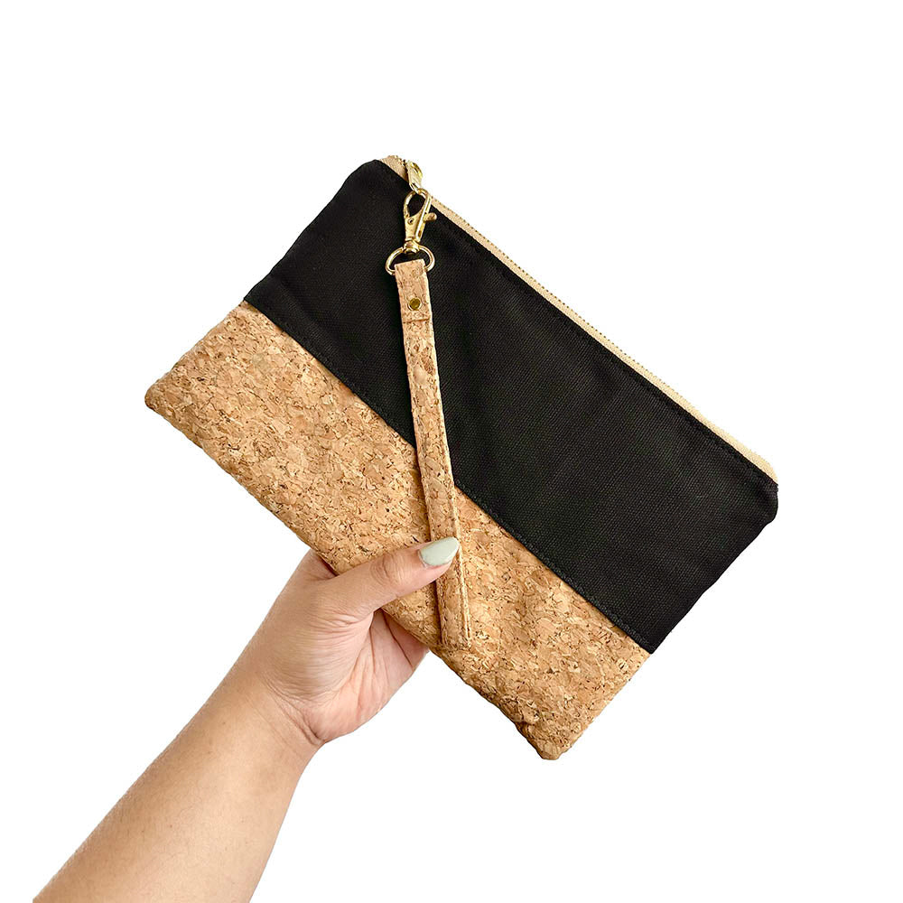 Model holding By The Sea Collection, Annie, black canvas vegan cork leather pouch