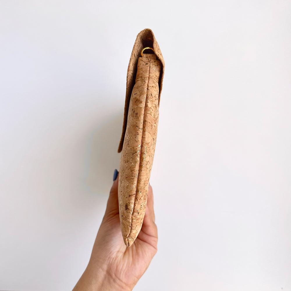 Model hand showing the sideway of By The Sea Collection, Aurora, gold vegan cork leather shoulder bag, clutch bag