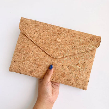 Model hand showing the front of By The Sea Collection, Aurora, gold vegan cork leather shoulder bag, clutch bag