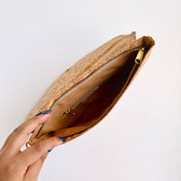 Model hand showing Interior lining of By The Sea Collection, Aurora, gold vegan cork leather shoulder bag, clutch bag