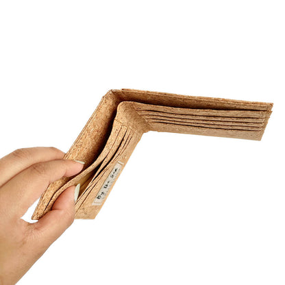 Model hand showing the interior of By The Sea Collection, Henry, classic vegan cork leather compact wallet