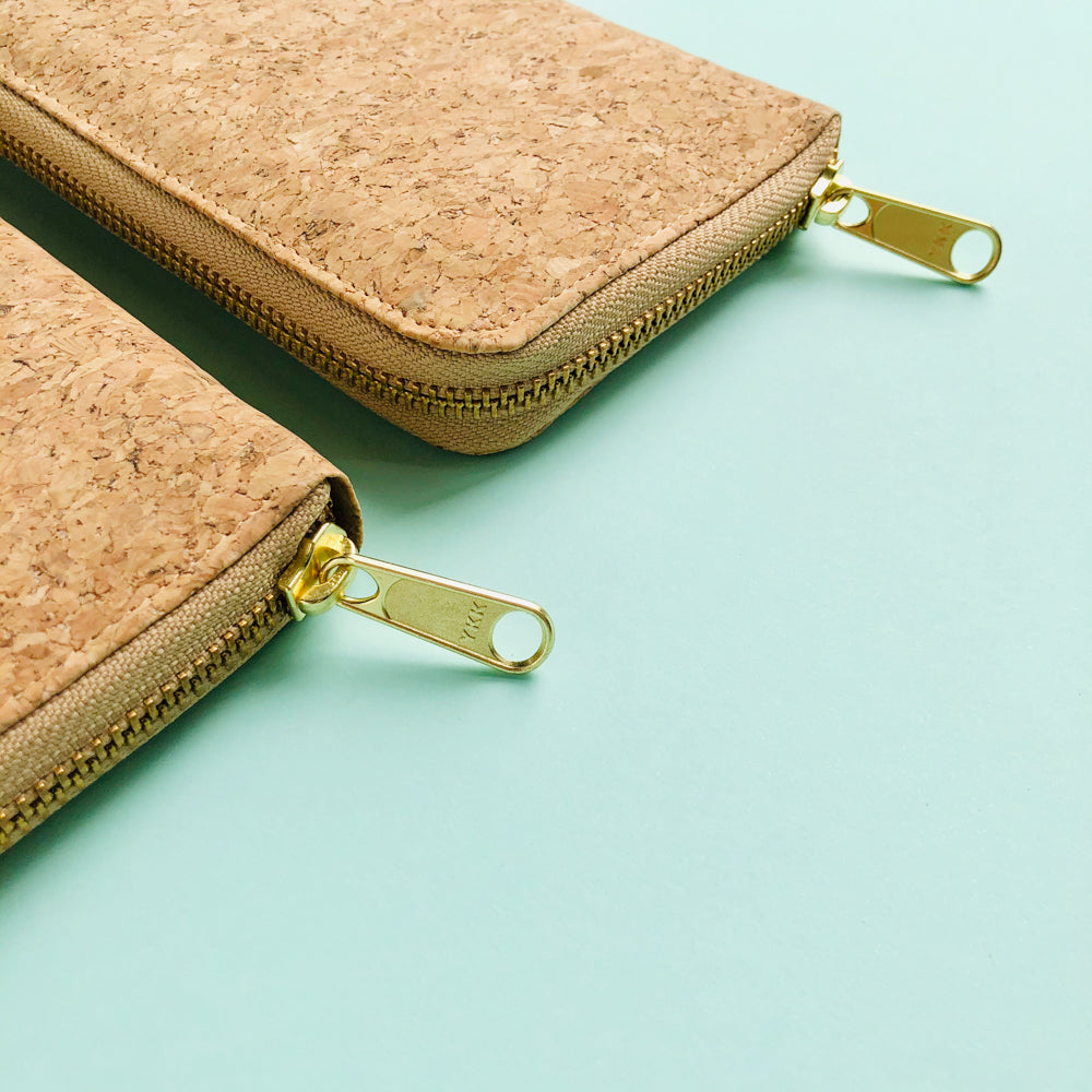 YKK metal zipper detail of two By The Sea Collection, Iggy, women’s vegan cork leather wallets