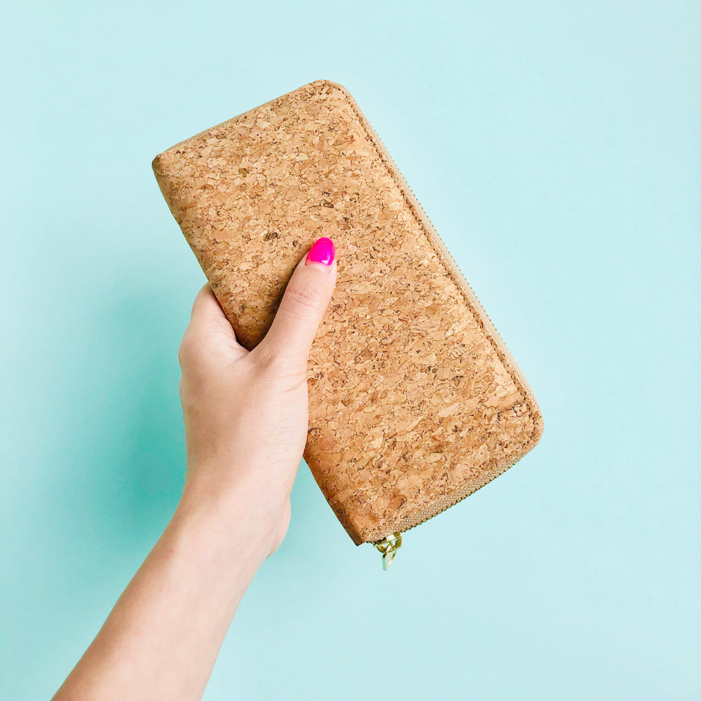 Woman holding By The Sea Collection, Iggy, women’s vegan cork leather wallet 