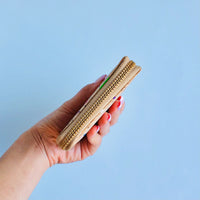 Model holding side view of By The Sea Collection, Ingy, colourful vegan cork leather wallet