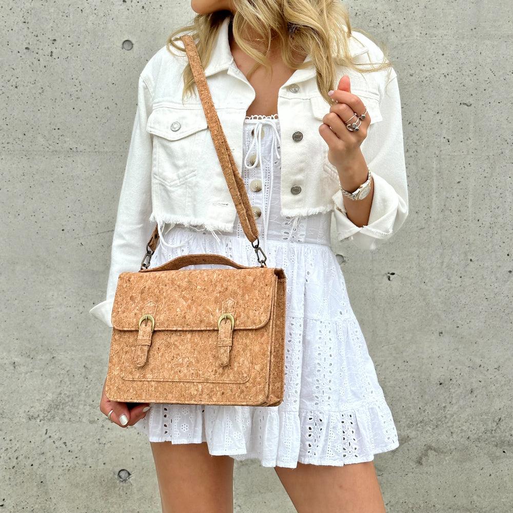 Model in white dress wearing sideway of By The Sea Collection, Keira, classic vegan cork leather handbag