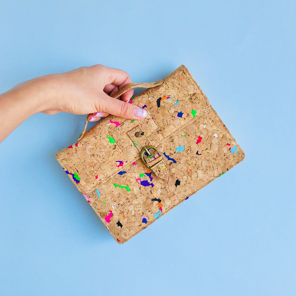 By The Sea Collection, model holding top handle of Kiki, colourful vegan cork leather mini shoulder bag