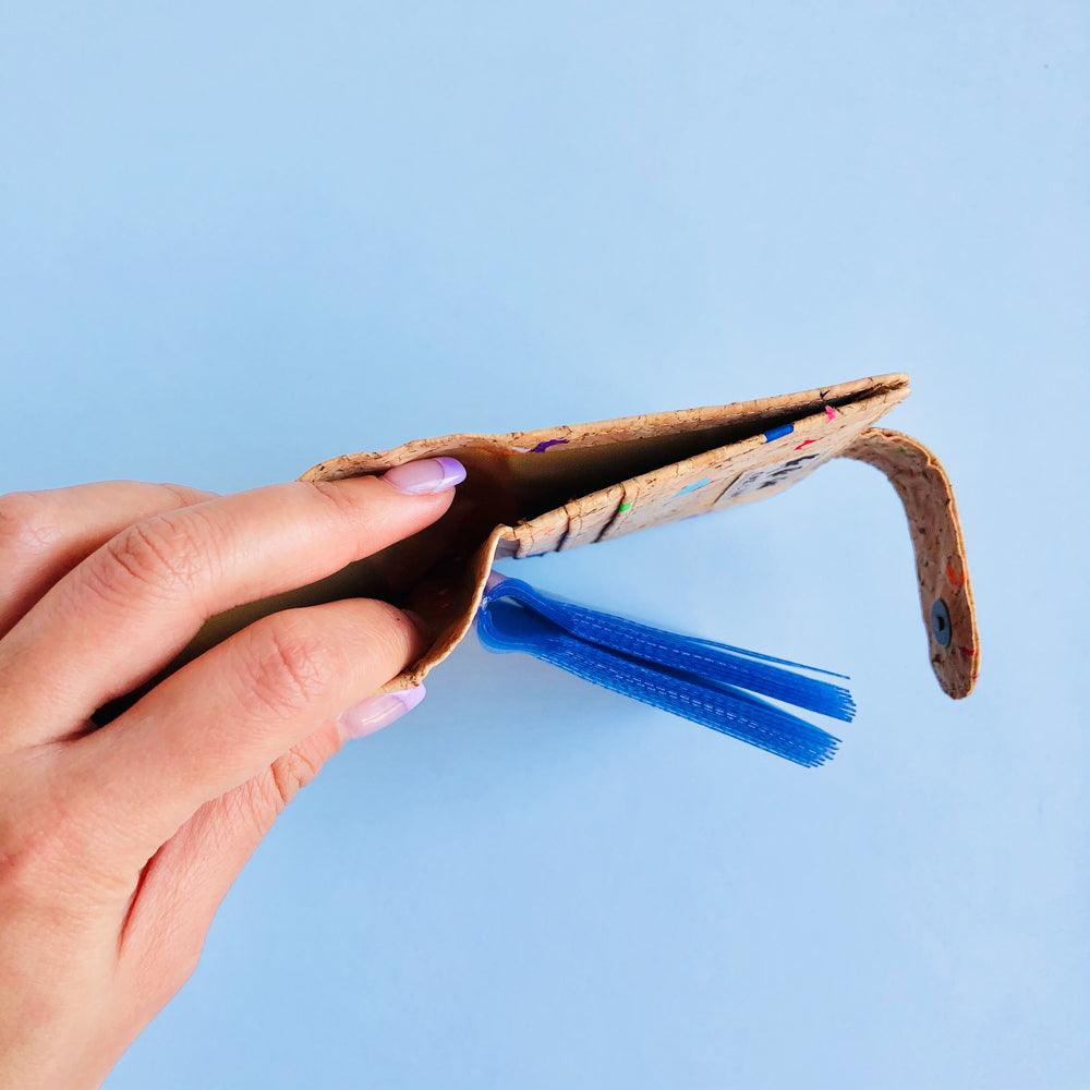 Model holding open bill compartment of By The Sea Collection, Kris, colourful vegan cork leather card holder wallet