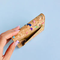 Model holding top view of By The Sea Collection, Laura, colourful vegan cork leather wallet