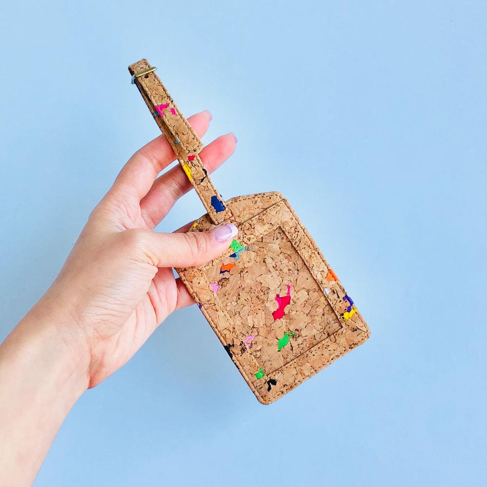 By The Sea Collection, model holding, Luke, colourful vegan cork leather luggage tag