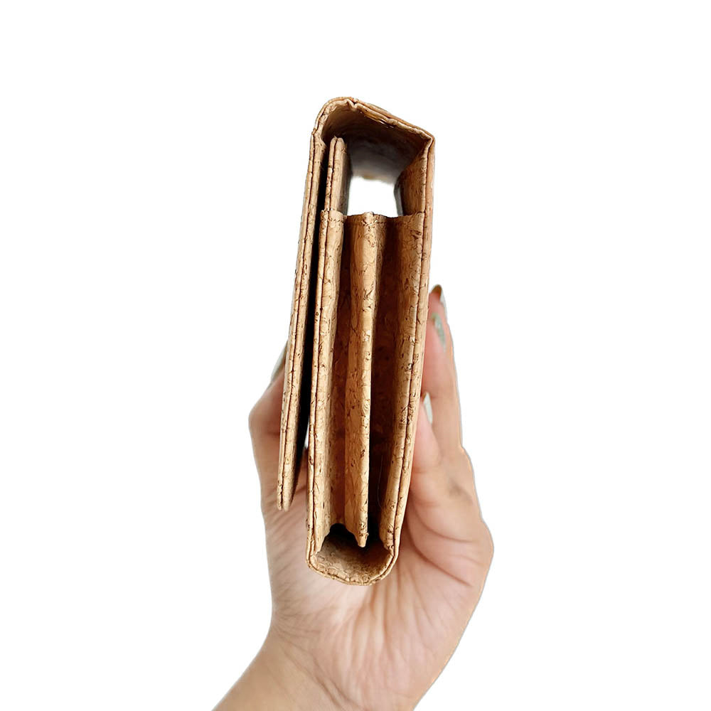 Model hand showing the side of By The Sea Collection, Lyla, classic vegan cork leather clutch