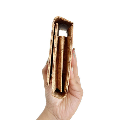 Model hand showing the side of By The Sea Collection, Lyla, classic vegan cork leather clutch