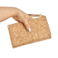 Model hand with wrist strap of By The Sea Collection, Lyla, classic vegan cork leather clutch