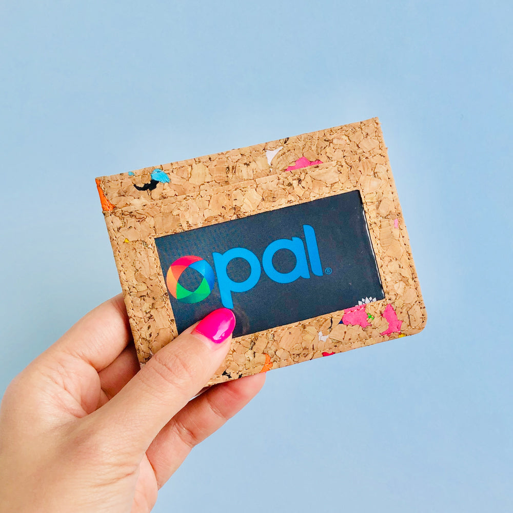 Woman holding of By The Sea Collection, Max, colourful vegan cork leather card holder with Opal Card