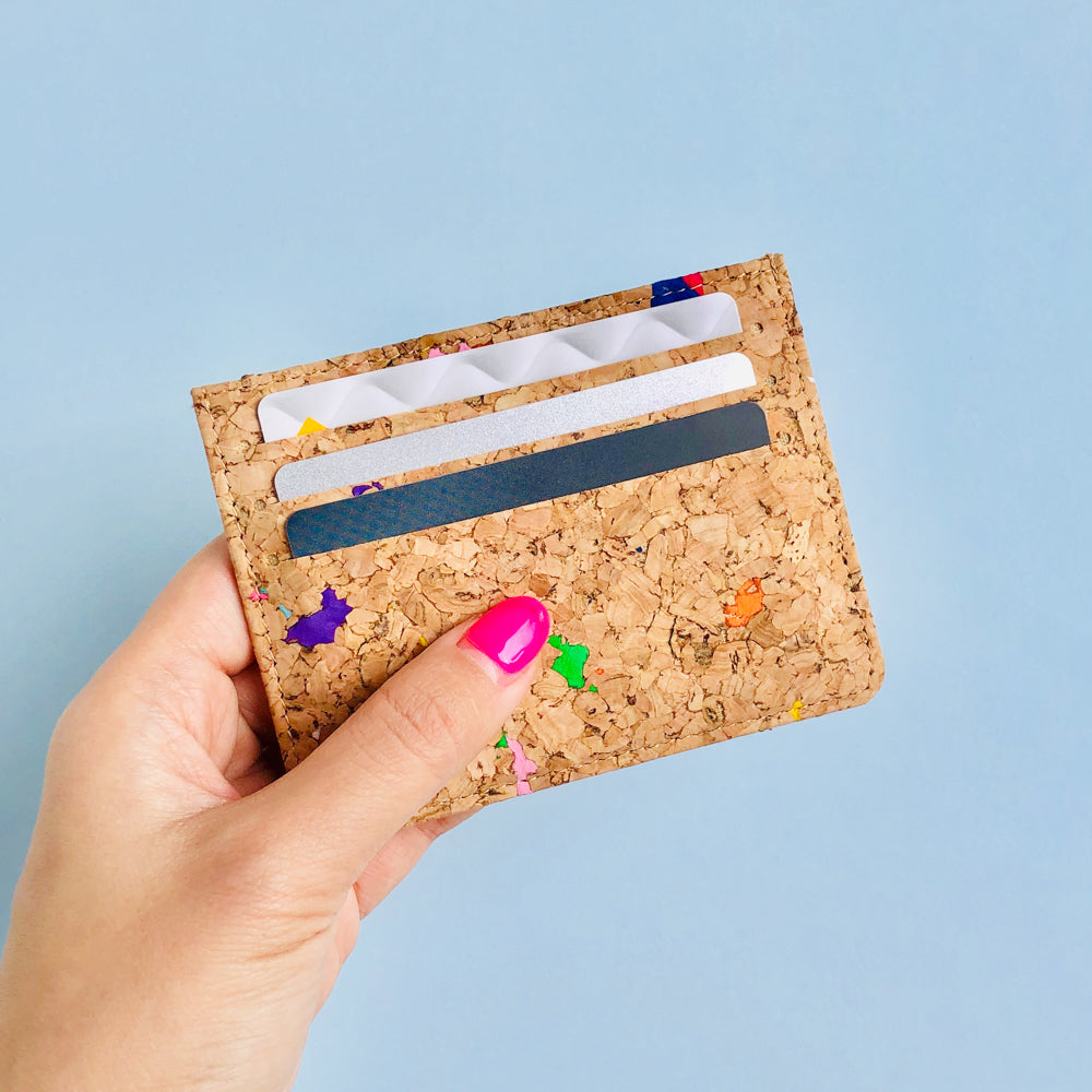 Woman holding of By The Sea Collection, Max, colourful vegan cork leather card holder full of cards
