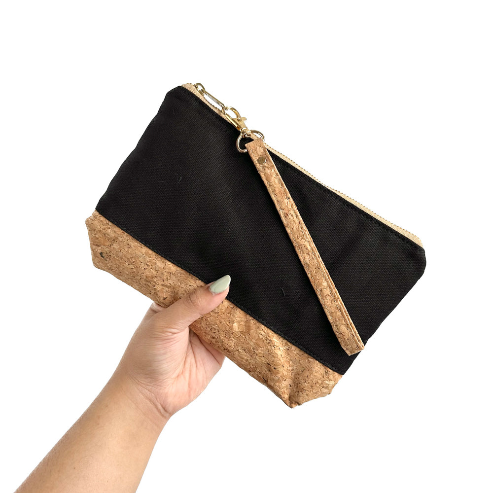 Model holding By The Sea Collection, Miley, black canvas vegan cork leather make up bag