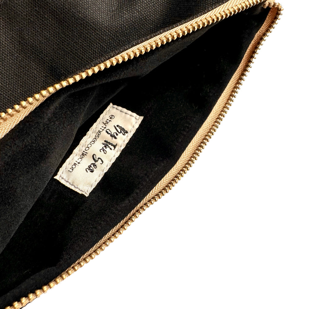 The interior lining of By The Sea Collection, Miley, black canvas vegan cork leather make up bag