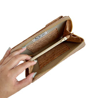 Model hand showing the inside of By The Sea Collection, Nyla, classic cork cross body phone bag