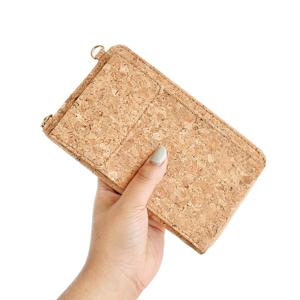 Model hand holding By The Sea Collection, Nyla, classic cork cross body phone bag