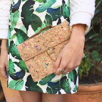 Model holding By The Sea Collection, Kiki, colourful vegan cork leather mini shoulder bag