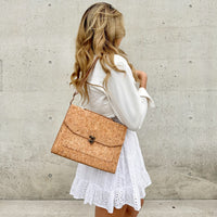 Model in white dress wearing on the shoulder By The Sea Collection, Tori classic vegan cork leather handbag